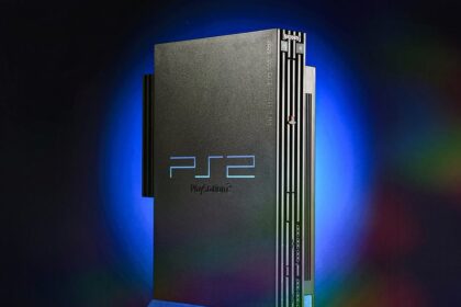 PlayStation 2 console with a selection of game cases, showcasing the iconic design and game library, celebrating its 25th anniversary.