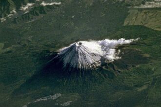 Mount Fuji ISS photograph, rare space view of iconic mountain, conical shape, snow cap, terrain detail.