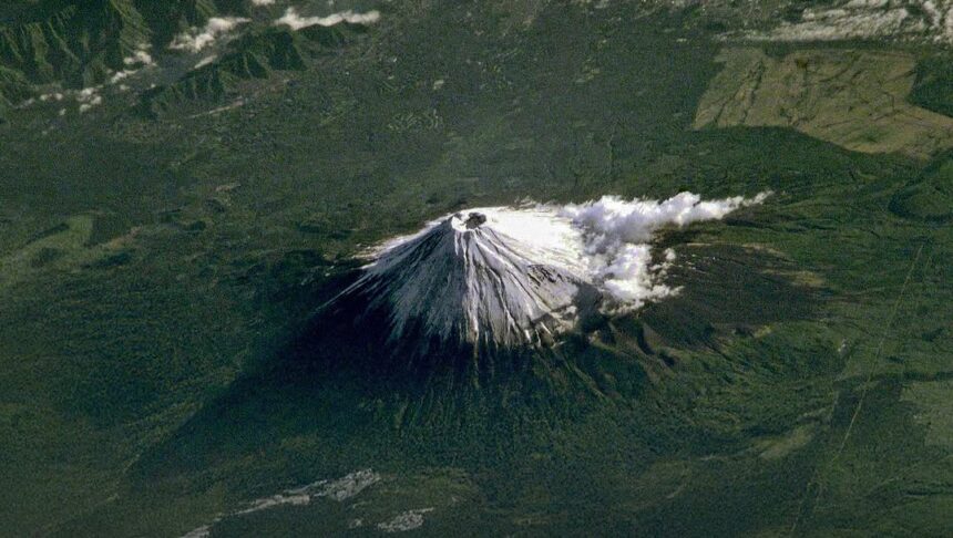 Mount Fuji ISS photograph, rare space view of iconic mountain, conical shape, snow cap, terrain detail.