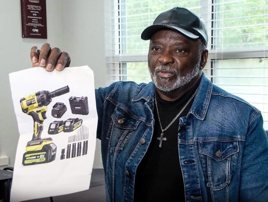 Sylvester Franklin, the victim of an AliExpress scam, holds up a low-resolution printed photo of a drill. The photo is in his hand, highlighting the discrepancy between the advertised product and the actual item received.